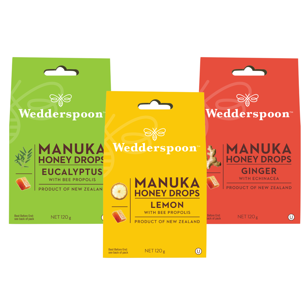 Three Wedderspoon Manuka Honey Drops packages in Eucalyptus, Lemon, and Ginger on a white background.