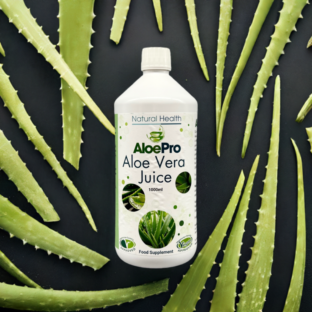 AloePro Aloe Vera Juice 1000ml white bottle with green label by Natural Health World UK surrounded by aloe leaves
