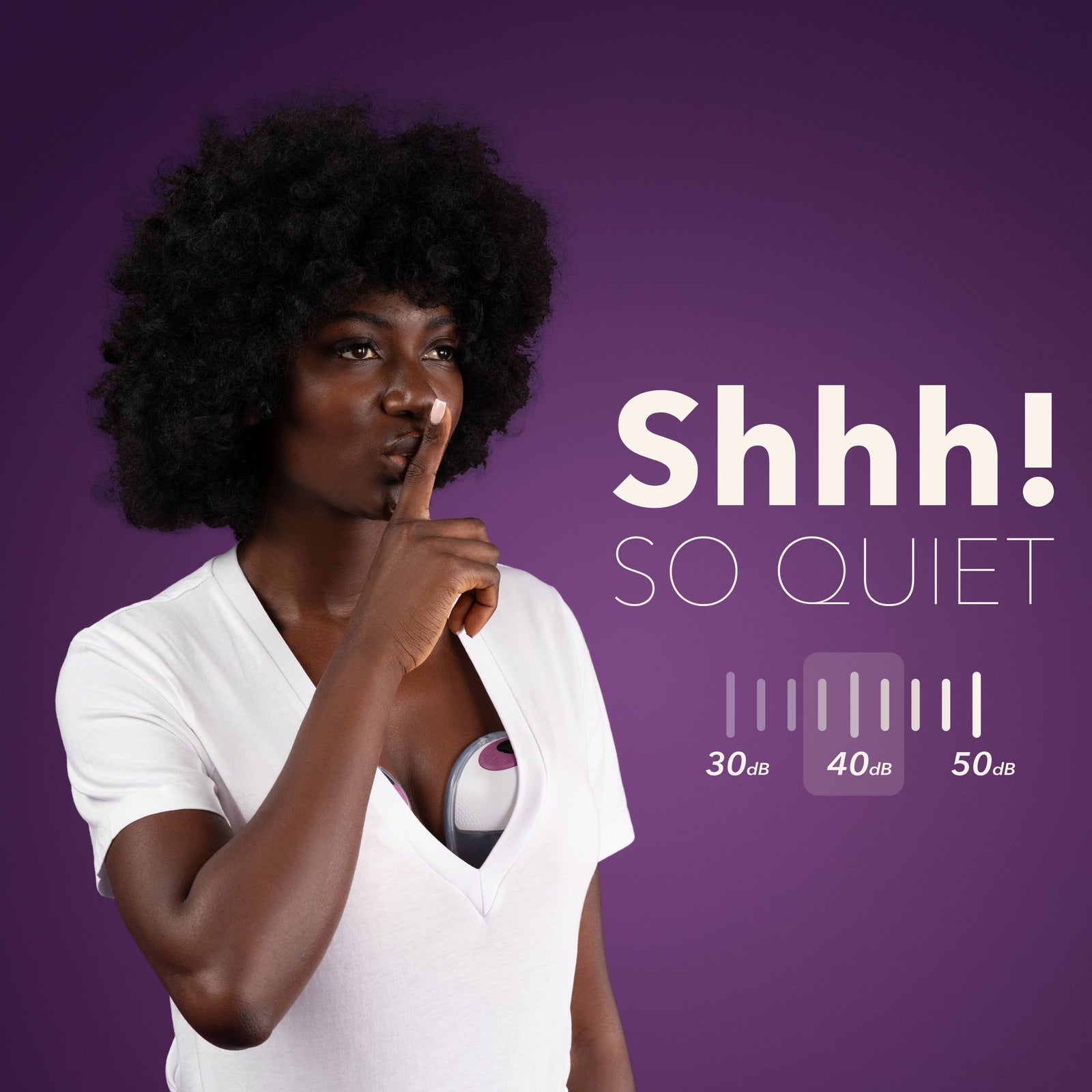 Woman using MOCHi wearable breast pump discreetly under white top showing its quiet operation