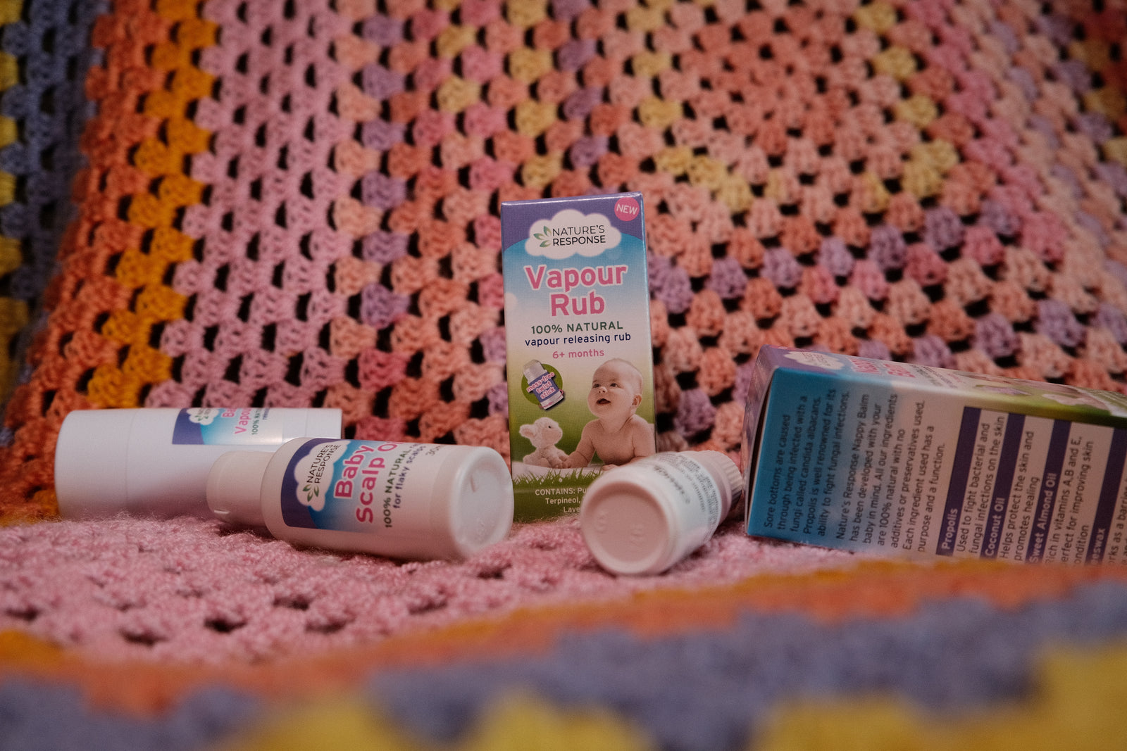 Natures Response Vapour Rub packaging and bottles on knitted baby blanket natural vapour rub for babies