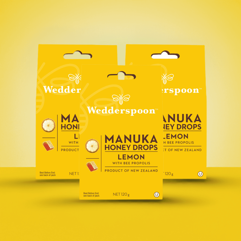 Wedderspoon packaging featuring Manuka honey drops lemon throat lozenges in bright yellow retail boxes