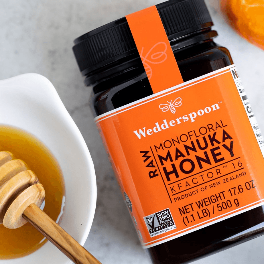 Wedderspoon raw Manuka honey KFactor 16 in a 500g jar with an orange label