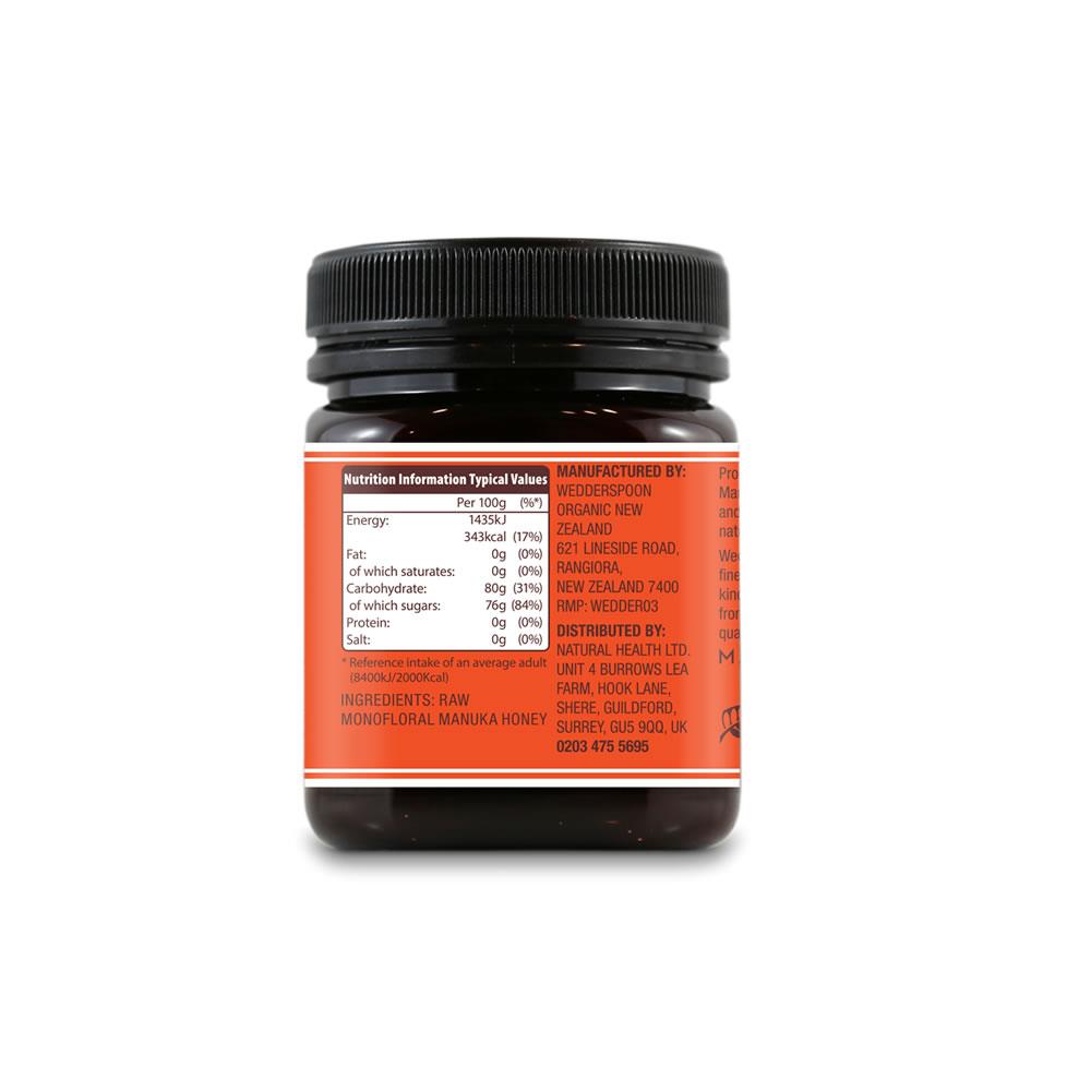 Rear view of Wedderspoon raw Manuka honey KFactor 16+ jar showing orange nutrition label and black lid