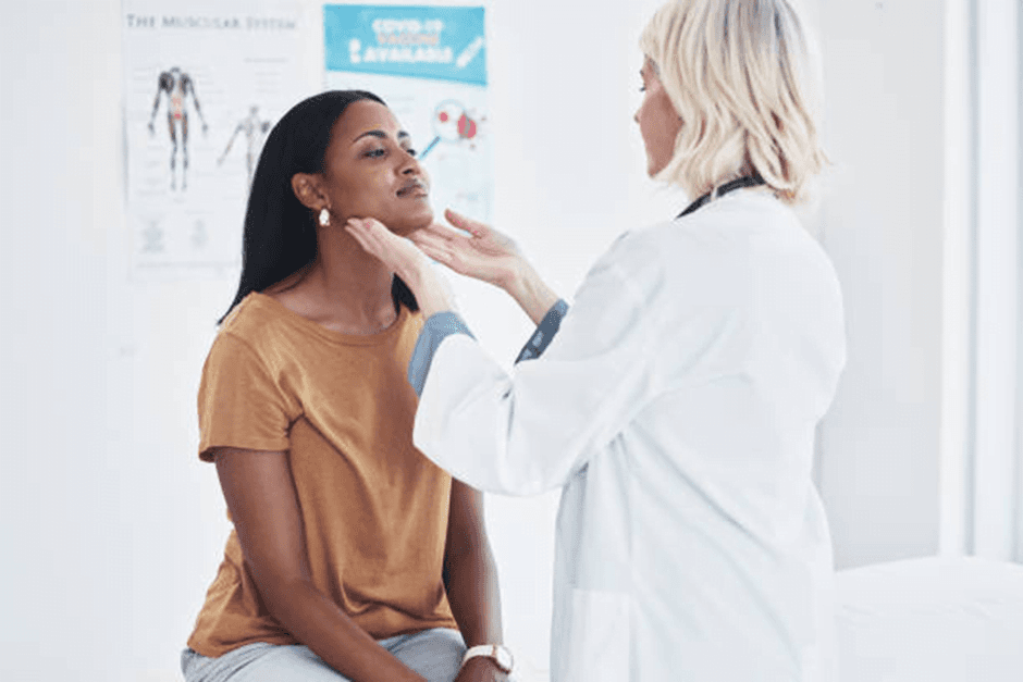 Doctor examining patient’s throat in clinic illustrating how to soothe a sore throat naturally