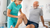 Physiotherapist examining a patient's leg in a clinical setting
