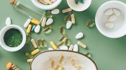 Assorted pills and supplements on a green background