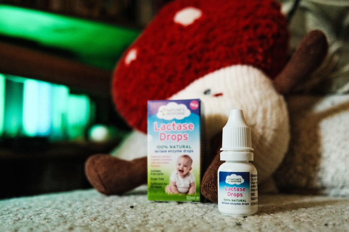 Natures Response natural lactase drops for babies bottle and box beside plush toy