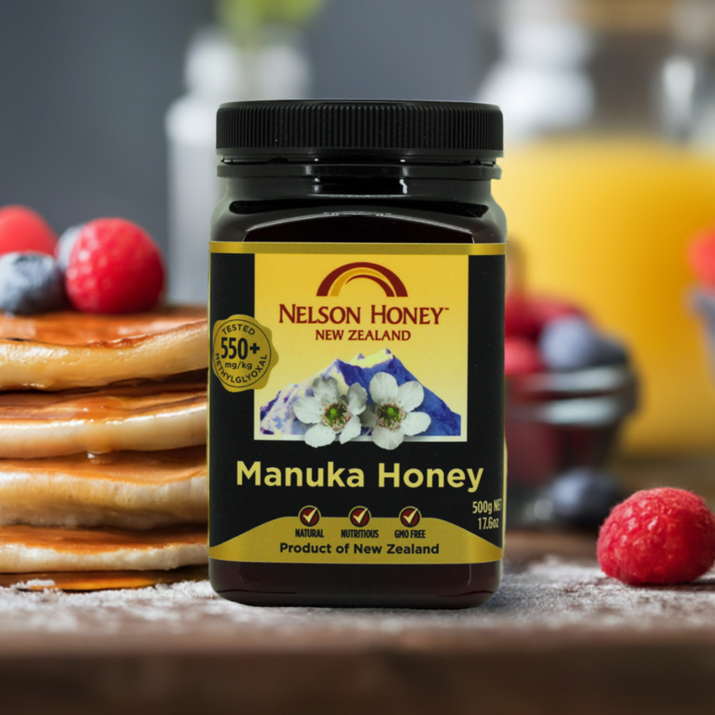 Nelson Honey jar of Manuka honey MGO 550 plus on breakfast table with pancakes and fresh berries