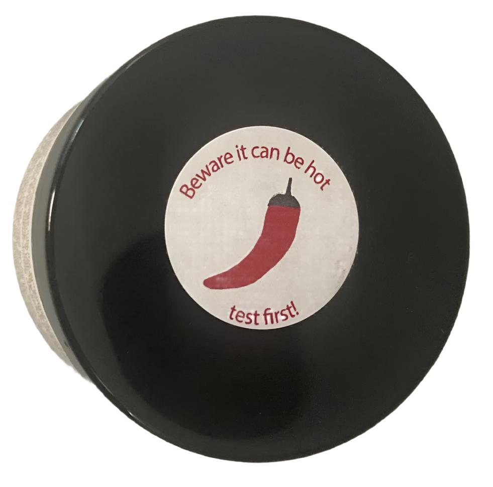 Power Health chilli warming balm for pain relief in black round jar with red chilli warning label