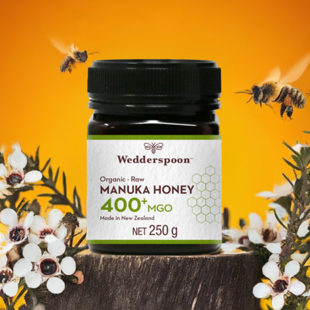 Wedderspoon high potency raw manuka honey 400 MGO in a 250g jar with bees and manuka flowers
