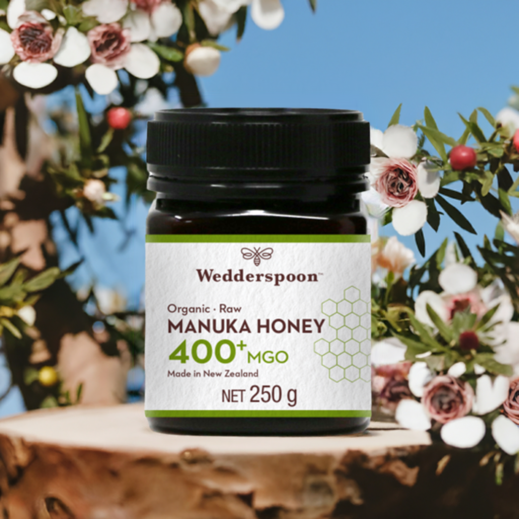 Wedderspoon high potency raw manuka honey 400 MGO jar 250g with floral background
