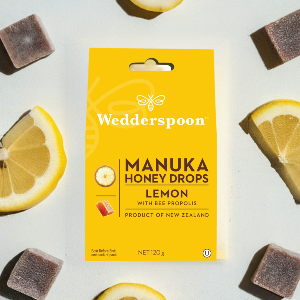 Wedderspoon Manuka honey drops lemon throat lozenges yellow box with lemon slices and lozenges