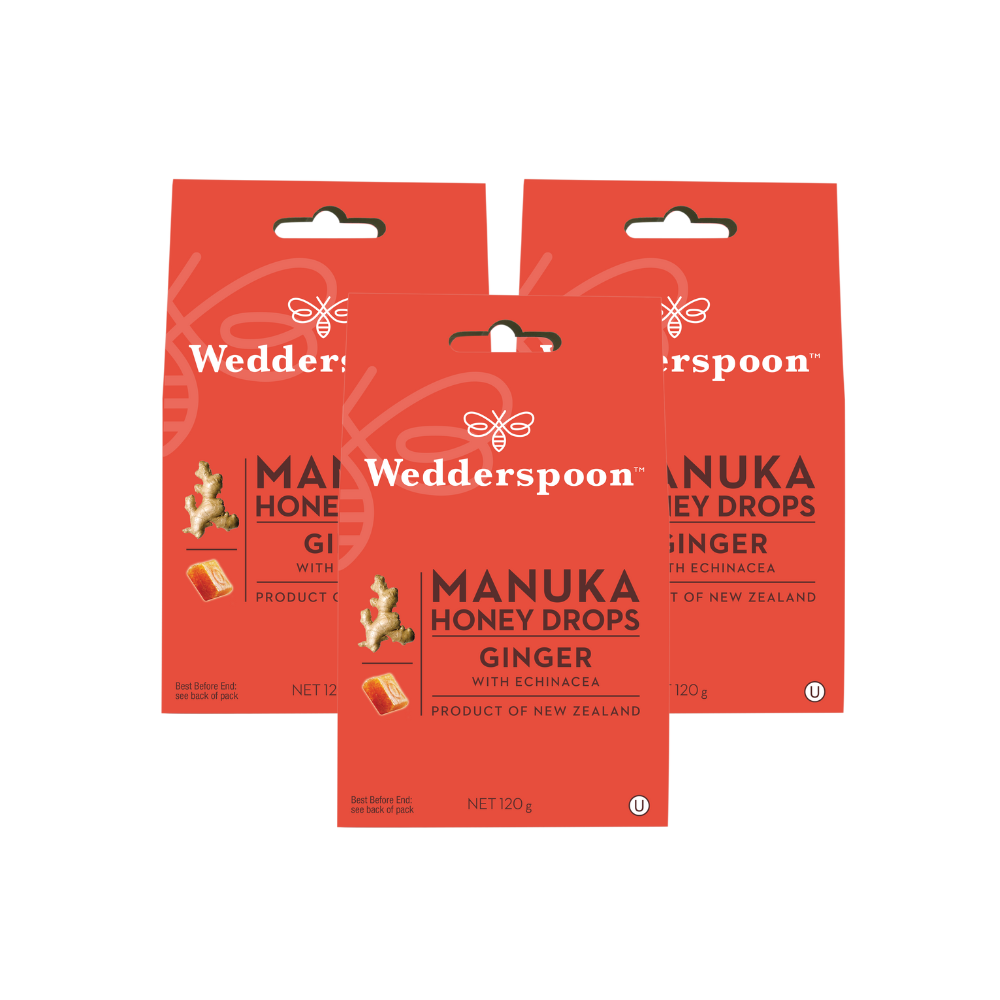 Wedderspoon Manuka honey drops with ginger throat lozenges three red retail packets showing packaging
