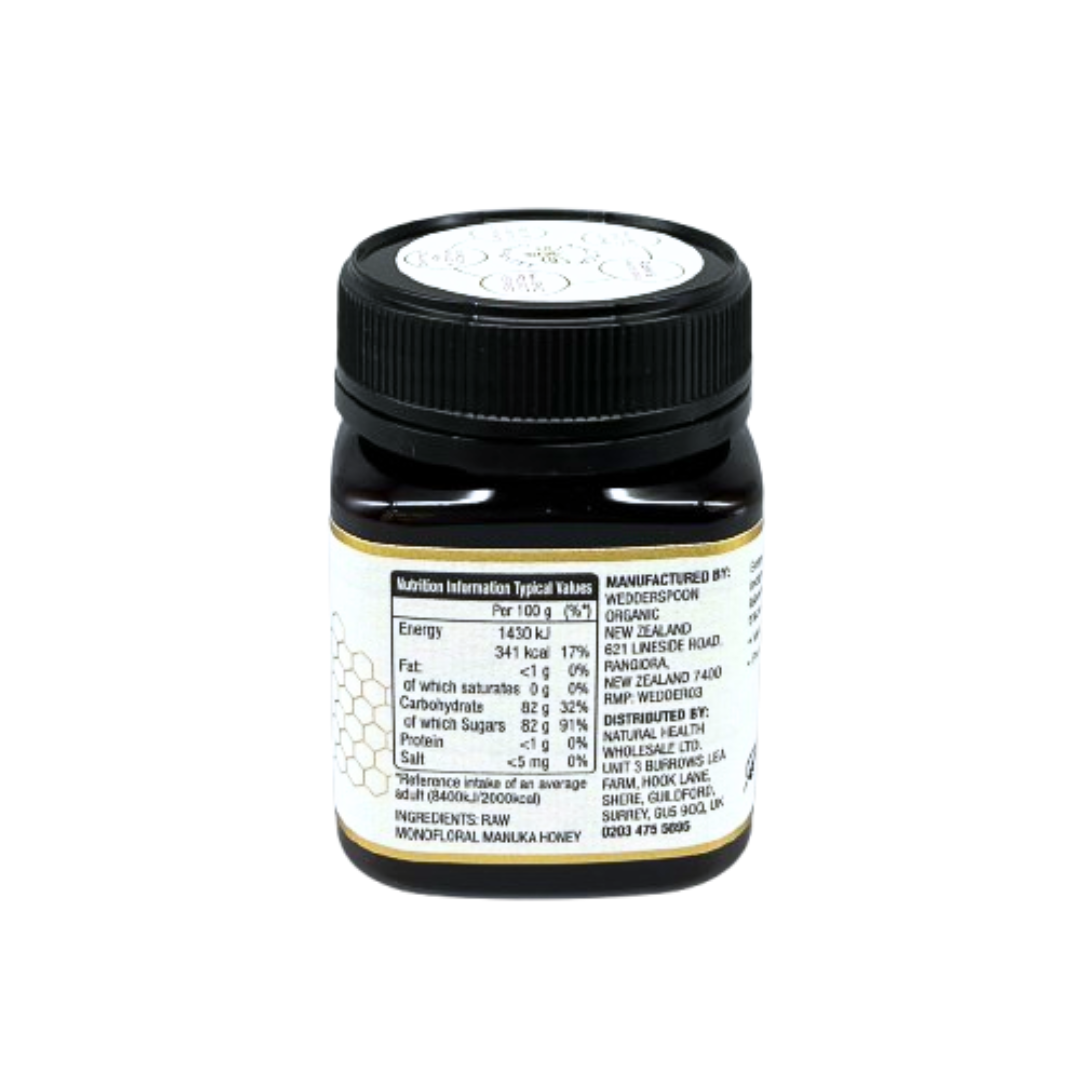 Wedderspoon jar of raw manuka honey 850 mgo in dark glass jar with black lid and visible nutrition label