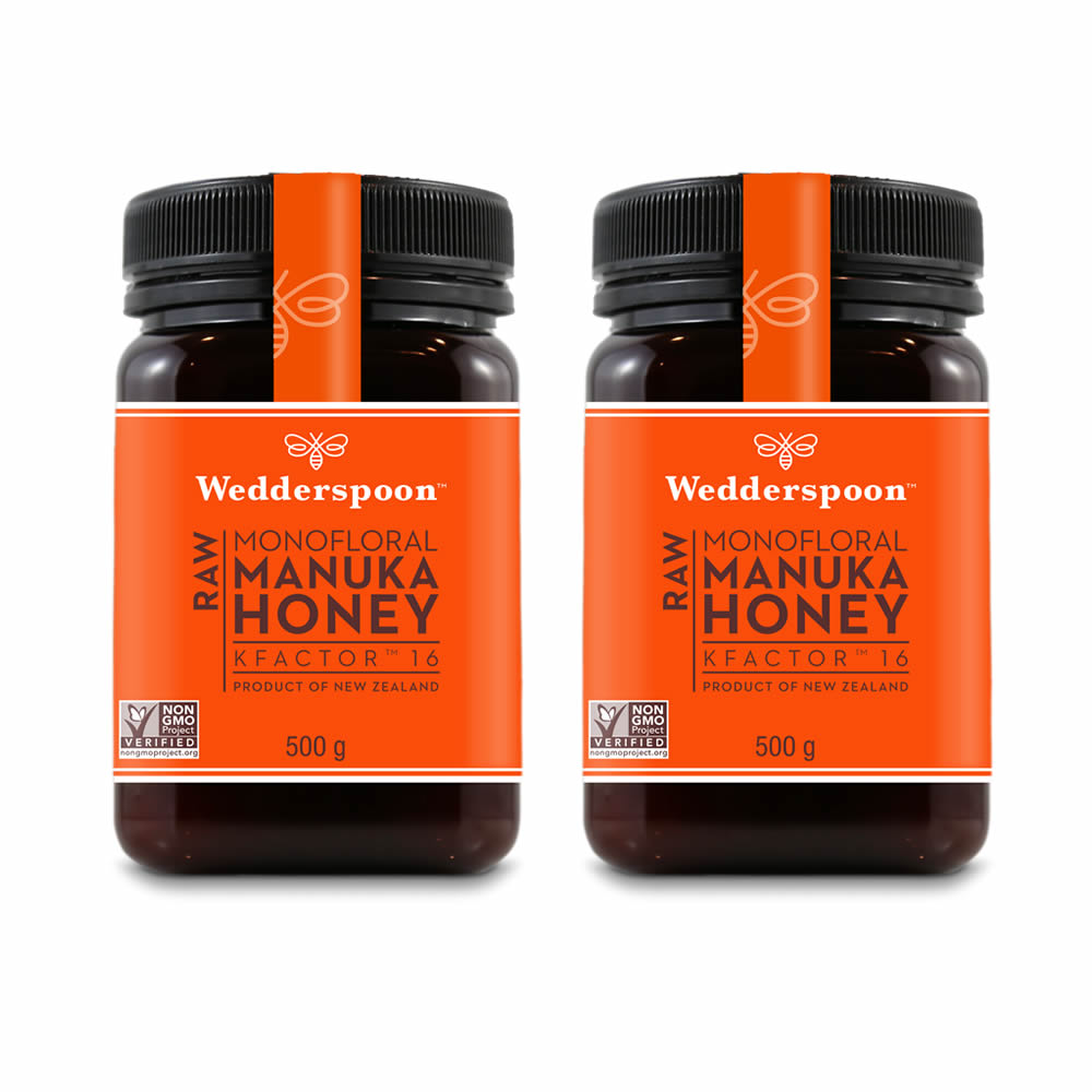 Two jars of Wedderspoon raw Manuka honey KFactor 16, each 500 g, featuring orange labels