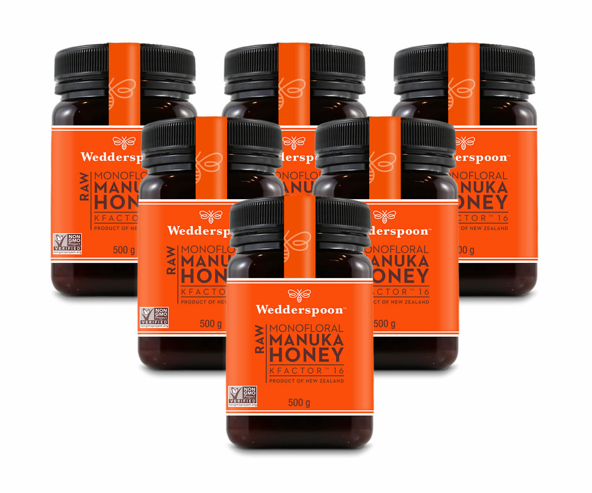 Six jars of Wedderspoon raw Manuka honey KFactor 16, each 500g, displayed together