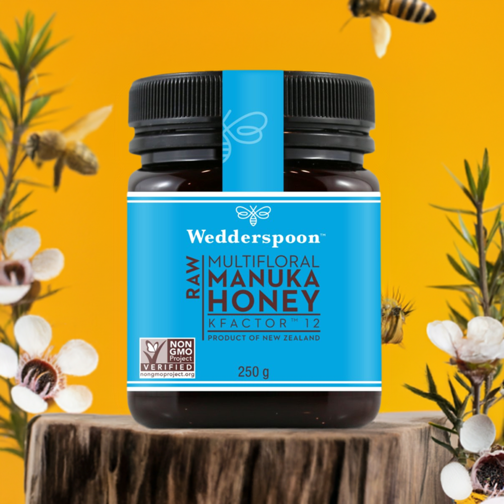 Wedderspoon Raw Manuka Honey KFactor 12 250g Triple floral honey jar on wooden surface with bees and flowers